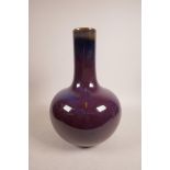 A Chinese purple glazed pottery bottle vase, seal mark to base, 13" high