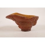 A Chinese horn and composition libation cup with carved kylin and dragon decoration, mark to base,