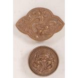 Two Chinese copper belt buckles, embossed with fiery dragons, largest 4" x 2½"