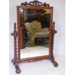 A C19th mahogany cheval mirror on barleytwist supports with carved decoration, 36" x 19", 48" high