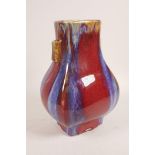 A Chinese flambé pottery vase with two lug handles, 4 character mark to base, 11" high