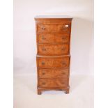 A walnut, six drawer bowfront tallboy on bracket feet, 21½" x 16½", 51" high