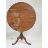 A C19th mahogany tilt top table on a turned column and tripod cabriole legs, split to top, 32"