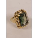 A 14ct gold cocktail ring with a large cushion cut green stone, possibly tourmaline, stamped,