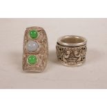 A Chinese white metal ring set with green and grey jade beads, together with a white metal archer'