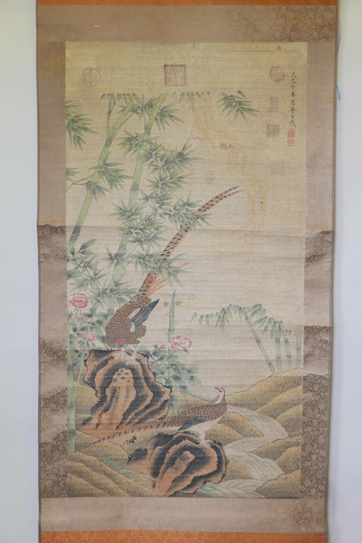 A Chinese watercolour scroll decorated with two pheasants in a landscape, 26" x 49"