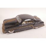 A vintage tinplate 'push and go' saloon car, 10" long