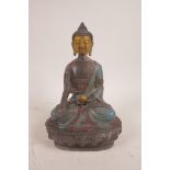 A Sino-Tibetan painted metal figure of Buddha with a gilt face, seated on a lotus throne, 8" high