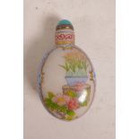 A Chinese enamelled glass snuff bottle with decorative floral panels, 3½" long