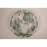 A Chinese famille verte pottery dish decorated with figures in a garden, 6 character mark to base,