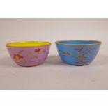 A pair of Chinese polychrome porcelain tea bowls with floral decoration, 6 character mark to base,