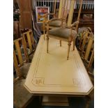 An Italian painted wood pedestal dining table and eight matching splat back chairs with carved and