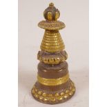 A Tibetan gilt and coppered bronze stupa, 4" high