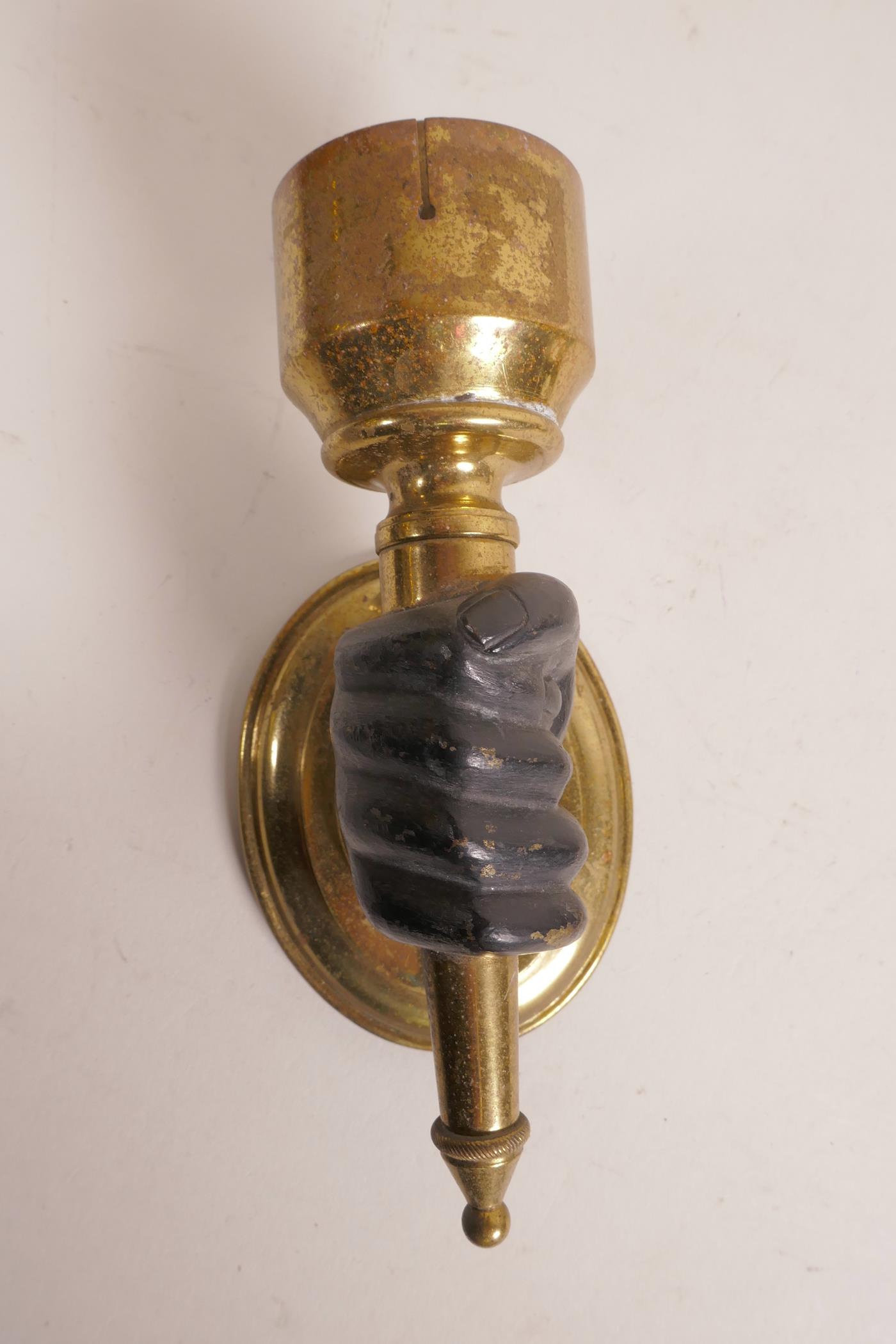 A pair of brass wall lights, with bronze hands clasping the torcheres, 6" high x 3" - Image 2 of 5