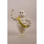 A painted cast iron novelty money box in the form of a Michelin Man, 8½" high