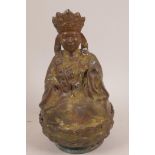A Chinese copper and bronze figurine of a deity seated on a lotus throne, 8½" high