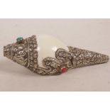 A white metal mounted conch shell set with turquoise and coral, 6" long