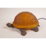 An amber and brown glass table lamp in the form of a tortoise, 8" long