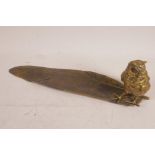 A cold painted bronze inkwell pen stand cast as an owl standing on a large feather, in the manner of