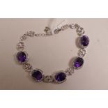 A silver and amethyst cabochon line bracelet
