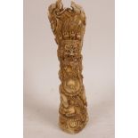 A Sino-Tibetan carved bone specimen vase with seal base decorated with an angry deity, 7" high