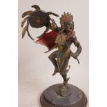 A cold painted bronze figurine of a Native American brave dancing a war dance, 11" high