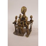 An African Benin brass figure group, 4½" high