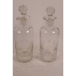 A pair of C19th glass decanters with star cut decoration, 11" high