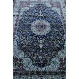 A Turkish carpet in traditional floral pattern on a blue field, 79" x 121"