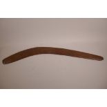 An antique Aboriginal boomerang with carved stylised snake decoration, 31½" long