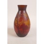 A cameo glass vase in the style of Daum, decorated with a wooded landscape, 6" high