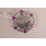 A sterling silver brooch depicting a ship at sail, set with semi precious stones, 1½" diameter