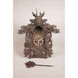 A late C19th Black Forest fusee cuckoo clock, with carved game decoration, 17½" wide, 20" high