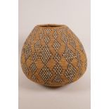 A South African woven grass Zulu basket, 9½" high