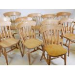 A set of ten beech Windsor lathe back kitchen chairs, and two associated elbow chairs