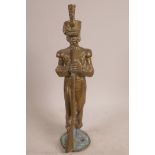 A heavy brass figurine of a C19th infantry officer holding a musket, 12" x 3½"