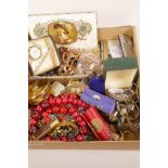 A box of costume jewellery etc and also including a crystal glass paperweight clock, compacts,