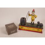 A cast iron 'Trick Dog' money box, 8" long, together with a tinplate wages tin, stamped BB&Co 2223