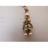 A 9ct gold charm pendant in the form of a clown, inset with rubies, sapphires, diamonds and