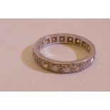 An early C20th white metal, diamond set full eternity ring, comprising eighteen stones, unmarked,