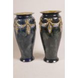 A pair of Royal Doulton stoneware vases with embossed swag decoration, 10½" high