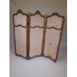 A C19th carved giltwood three fold screen inset with watered silk panels, A/F losses, each door