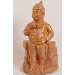 A German earthenware tobacco jar modelled as a corpulent military officer in a Pickelhelm, 13" high