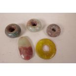A collection of five Chinese hardstone, jade and soapstone pendants, 2½" diameter largest
