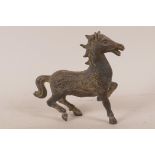 A Chinese bronze figurine of a horse, the body decorated with a dragon and phoenix, 5¾" high