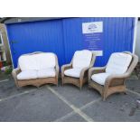 A woven wicker and rattan conservatory suite comprising two seater settee and two armchairs with