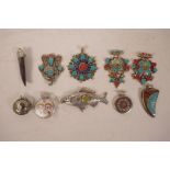 A collection of ten Tibetan white metal and hardstone pendants