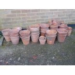 A quantity of terracotta flower pots, largest 8" high