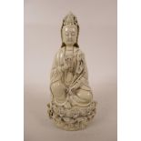 A Chinese blanc de chine Quan Yin, seated on a lotus throne, 10½" high