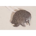 A silver pendant/brooch in the form of an Australian echidna, marked STO.SIL, and indistinct maker's